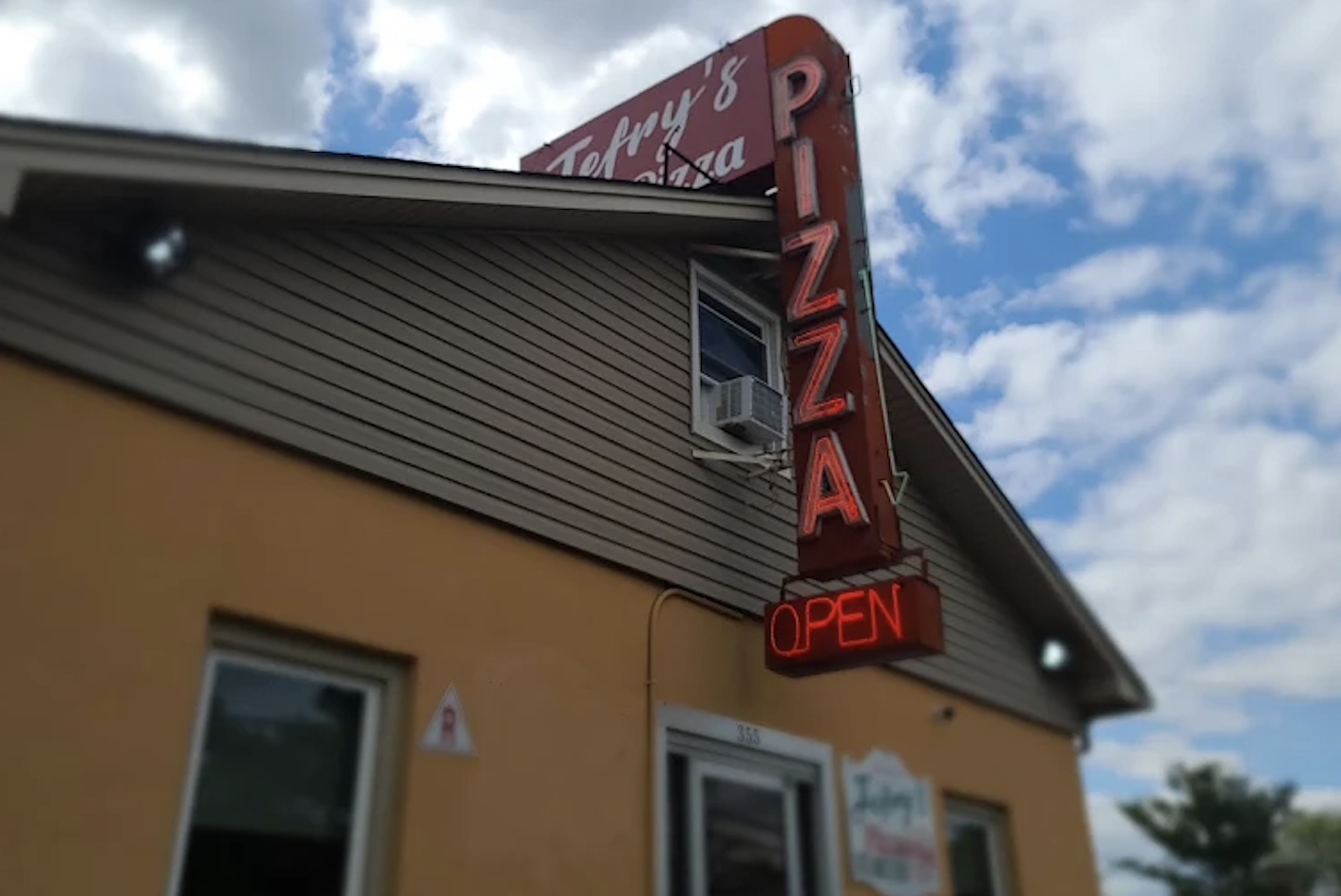 Jefry's Pizza Parsippany storefront with neon pizza sign in Parsippany, New Jersey